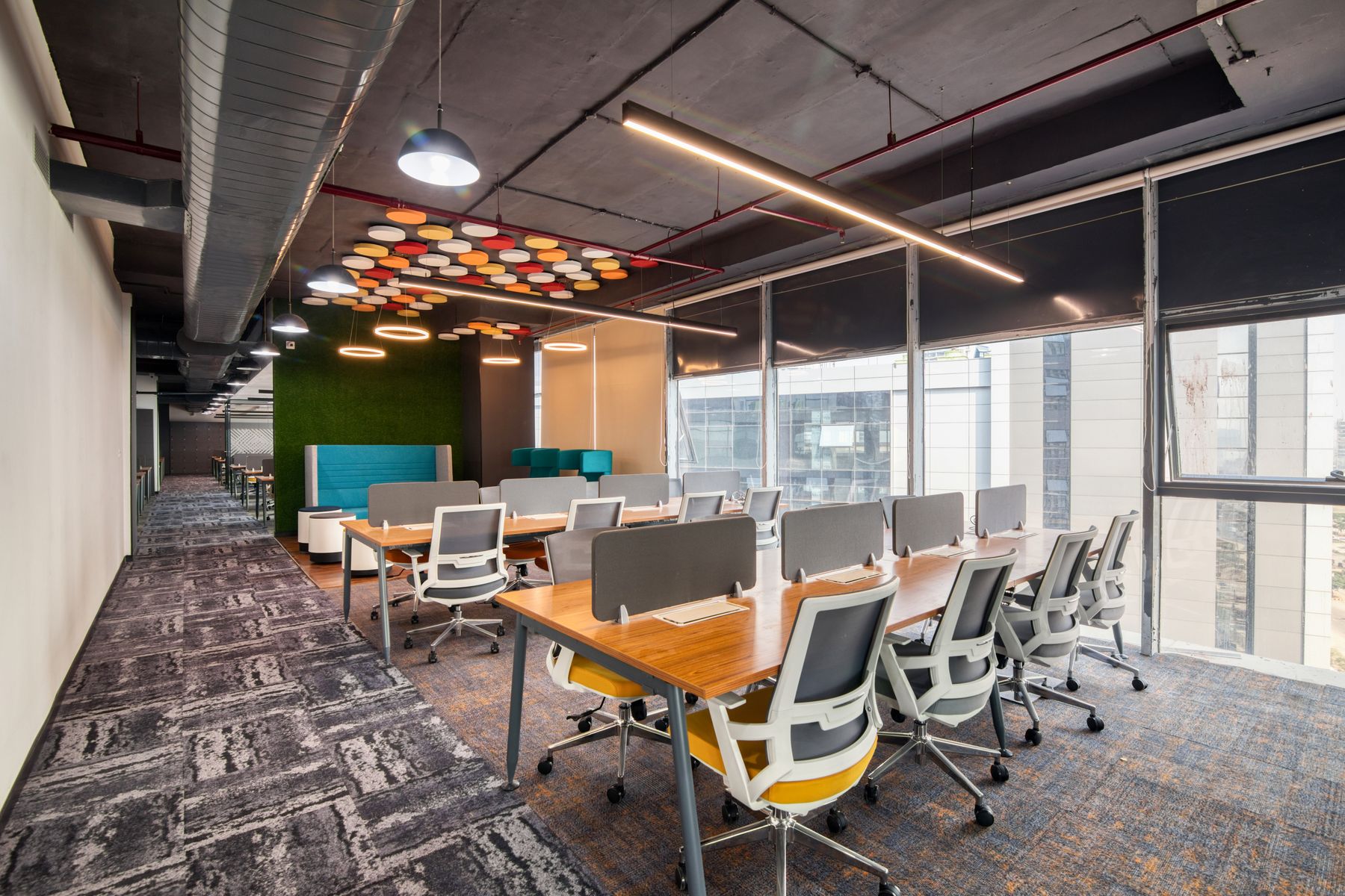 Open commercial workspace with desks and exposed ceiling