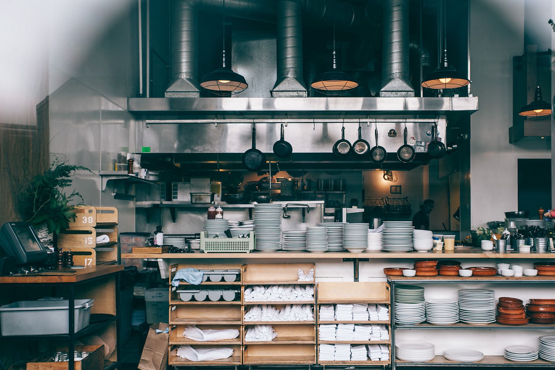 Working restaurant kitchen with stainless hood and prep line